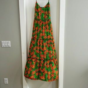 Maxi dress with spaghetti straps. Orange with green background